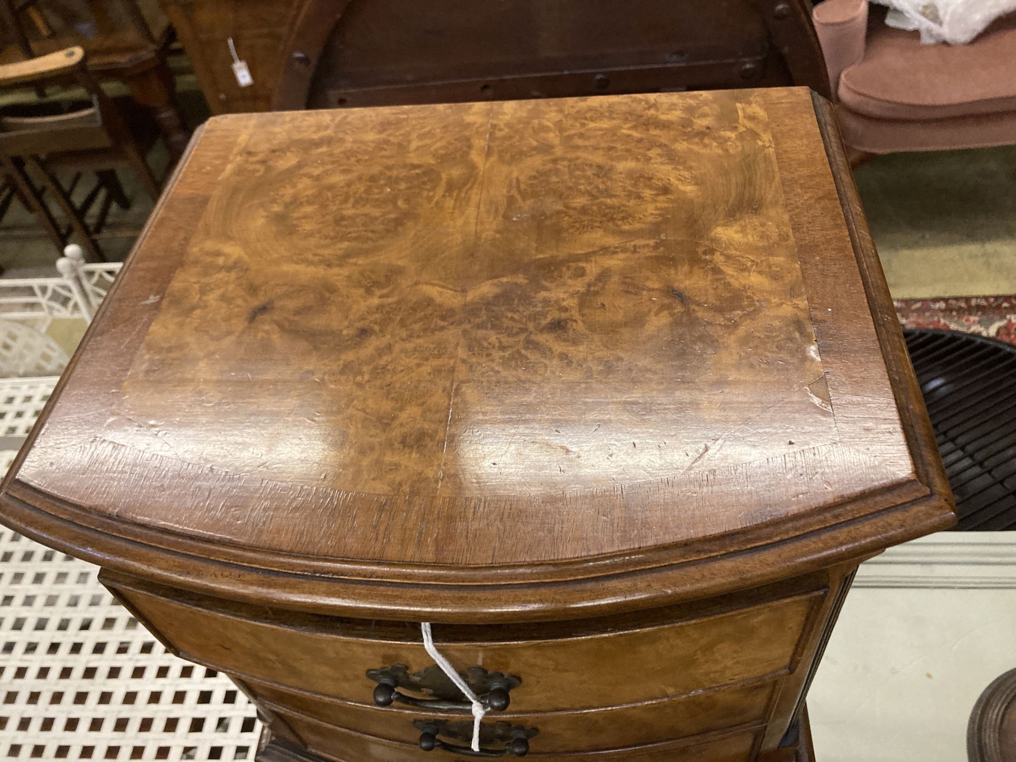 A reproduction walnut four drawer bedside chest, width 42cm depth 29cm height 76cm